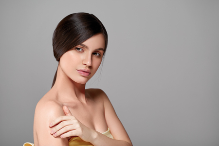 Beautiful perfect hair woman portrait. Studio shot. Gray background.の写真素材