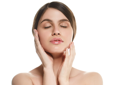 Beautiful Woman Face Portrait Beauty Skin Care Concept Beautiful beauty young female model girl touching her face skin cheeks hands fingers. Fashion Beauty Model isolated on whiteの写真素材