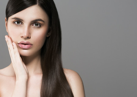 Beautiful perfect hair woman portrait. Studio shot. Gray background.の写真素材