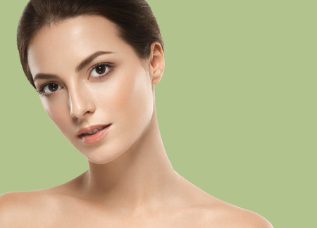Beautiful Woman Girl brunette hair on summer green trendy color background. Studio shot.の写真素材