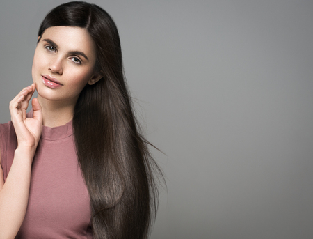 Beautiful perfect hair woman portrait. Studio shot. Gray background.の写真素材