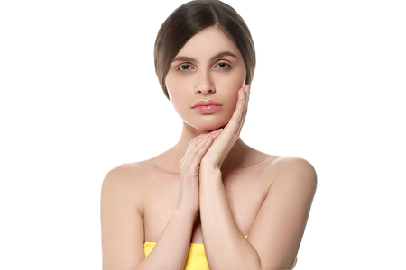 Beautiful Woman Face Portrait Beauty Skin Care Concept Beautiful beauty young female model girl touching her face skin cheeks hands fingers. Fashion Beauty Model isolated on whiteの写真素材