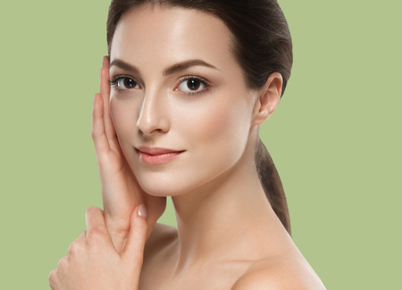 Beautiful Woman Girl brunette hair on summer green trendy color background. Studio shot.の写真素材