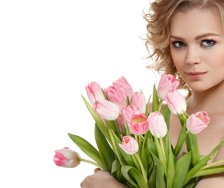 Beautiful woman portrait with flowers tulips and curly amazing hair isolated on whiteの写真素材