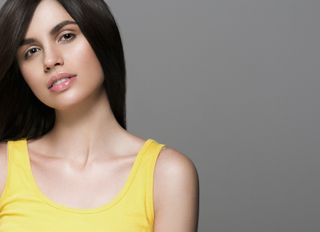 Beautiful perfect hair woman portrait. Studio shot. Gray background.の写真素材