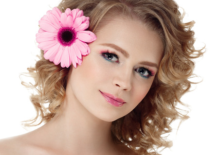 Woman beauty portrait with lower in hair curly blond hair isolated on white. Studio shot.の写真素材