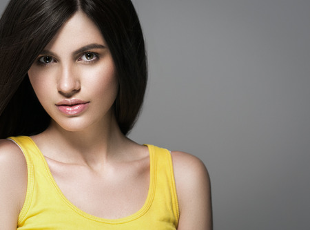 Beautiful perfect hair woman portrait. Studio shot. Gray background.の写真素材