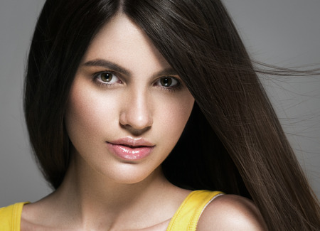 Beautiful perfect hair woman portrait. Studio shot. Gray background.の写真素材
