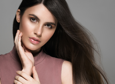 Beautiful perfect hair woman portrait. Studio shot. Gray background.の写真素材