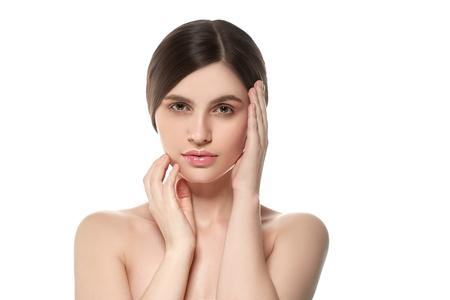 Beautiful Woman Face Portrait Beauty Skin Care Concept Beautiful beauty young female model girl touching her face skin cheeks hands fingers. Fashion Beauty Model isolated on whiteの写真素材