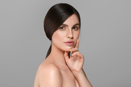 Beautiful perfect hair woman portrait. Studio shot. Gray background.の写真素材