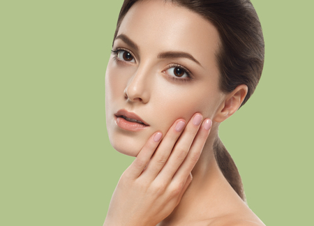 Beautiful Woman Girl brunette hair on summer green trendy color background. Studio shot.の写真素材