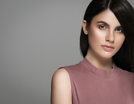 Beautiful perfect hair woman portrait. Studio shot. Gray background.の写真素材