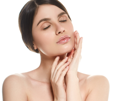 Beautiful Woman Face Portrait Beauty Skin Care Concept Beautiful beauty young female model girl touching her face skin cheeks hands fingers. Fashion Beauty Model isolated on whiteの写真素材