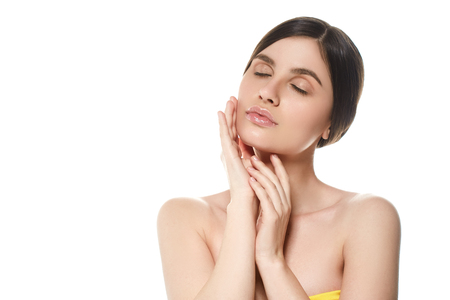 Beautiful Woman Face Portrait Beauty Skin Care Concept Beautiful beauty young female model girl touching her face skin cheeks hands fingers. Fashion Beauty Model isolated on whiteの写真素材