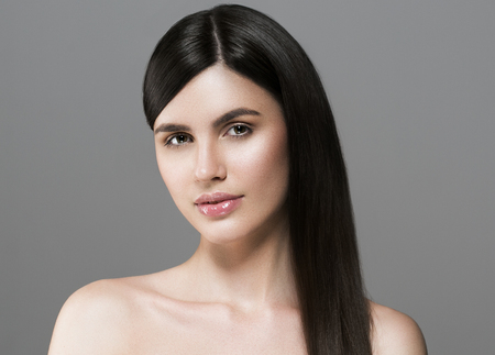 Beautiful perfect hair woman portrait. Studio shot. Gray background.の写真素材