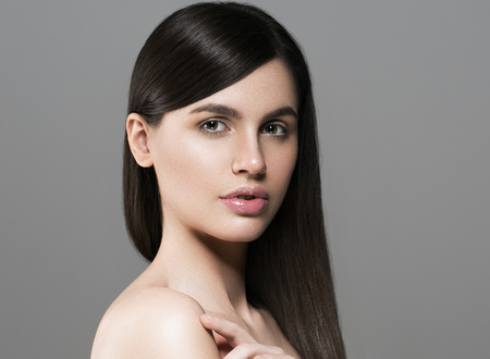 Beautiful perfect hair woman portrait. Studio shot. Gray background.の写真素材