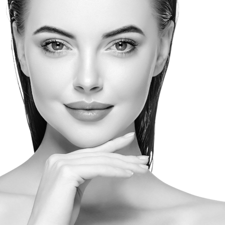 Woman face young beautiful healthy skin portrait with hands black and white. Studio shot.の写真素材