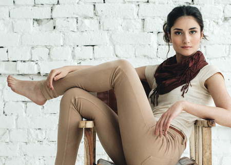 Woman portrait natural beautiful casual beautiful people. Studio shot. Stone wall background.の写真素材