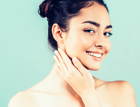 Beautiful Woman Face with hands Portrait Beauty Skin Care Concept. Fashion Beauty Model isolated on gray backgroundの写真素材