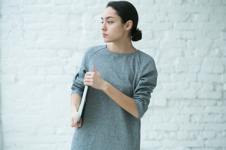 Beautiful Woman with Laptop. Indoor shot.の写真素材