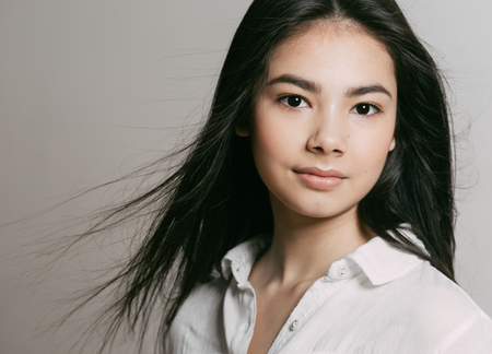 Asian woman girl beauty portrait. Studio shot. Gray background.の写真素材
