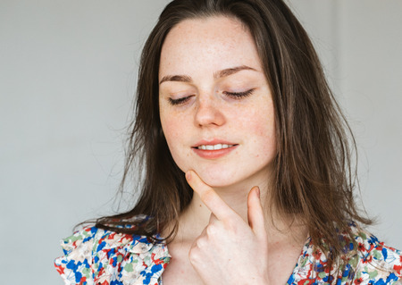 Young beautiful woman freckles natural portraitの写真素材
