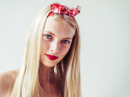Beautiful pinup woman with long blonde hair natural on white background. Studio shot.の写真素材