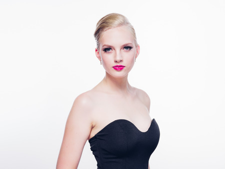 Beautiful blonde woman with red lipstick and classic fashion style isolated on white female beauty. Studio shot.の写真素材
