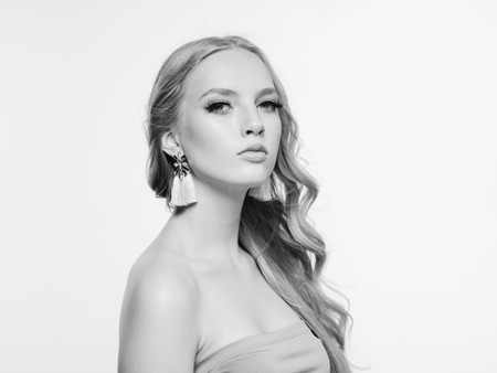 Blonde long hair woman beauty portrait with beautiful hairstyle isolated on white monochromeの写真素材