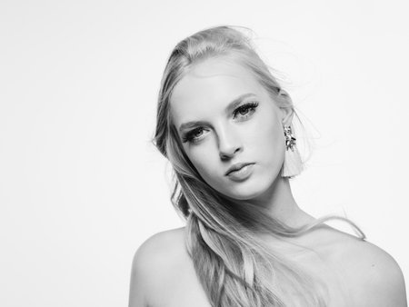 Blonde long hair woman beauty portrait with beautiful hairstyle isolated on white monochromeの写真素材