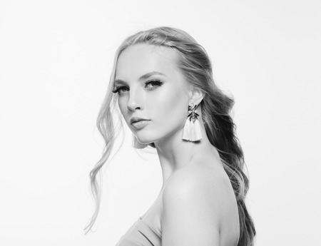 Blonde long hair woman beauty portrait with beautiful hairstyle isolated on white monochromeの写真素材