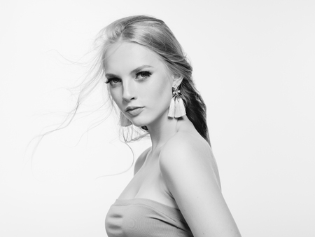 Blonde long hair woman beauty portrait with beautiful hairstyle isolated on white monochromeの写真素材