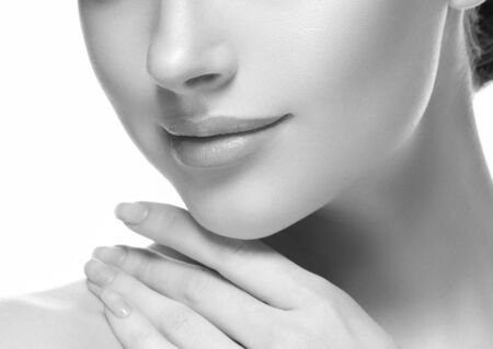 Woman lips cosmetic monochrome  neck chin and ceeks beauty. Studio shot.の写真素材