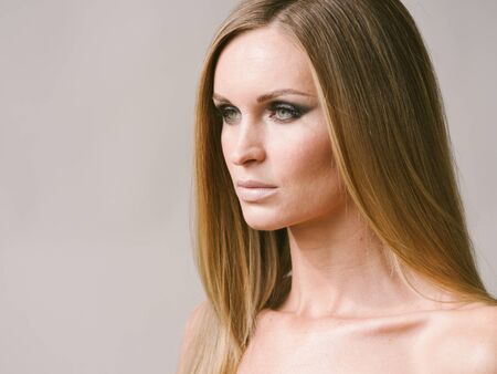 Beautiful woman long hair blonde natural portrait with beauty makeup. Studio shot.の写真素材