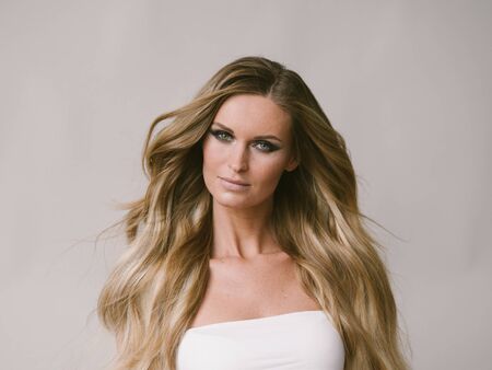 Beautiful woman long hair blonde natural portrait with beauty makeup. Studio shot.の写真素材