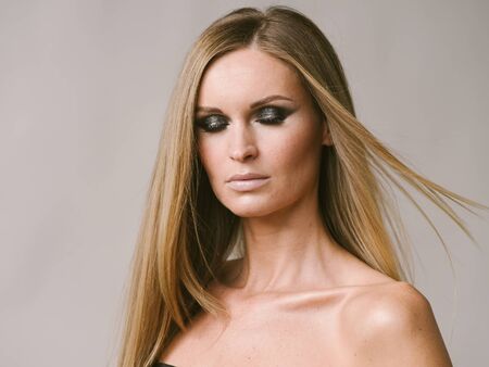 Beautiful woman long hair blonde natural portrait with beauty makeup. Studio shot.の写真素材