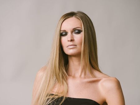 Beautiful woman long hair blonde natural portrait with beauty makeup. Studio shot.の写真素材