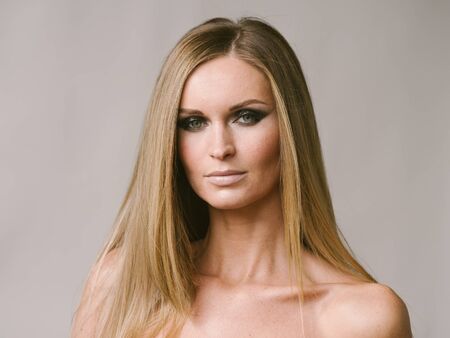 Beautiful woman long hair blonde natural portrait with beauty makeup. Studio shot.の写真素材
