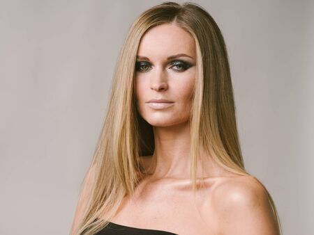 Beautiful woman long hair blonde natural portrait with beauty makeup. Studio shot.の写真素材