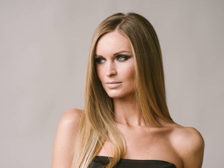 Beautiful woman long hair blonde natural portrait with beauty makeup. Studio shot.の写真素材