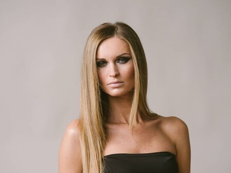 Beautiful woman long hair blonde natural portrait with beauty makeup. Studio shot.の写真素材
