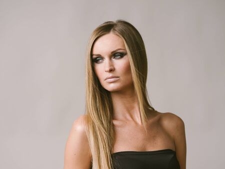 Beautiful woman long hair blonde natural portrait with beauty makeup. Studio shot.の写真素材