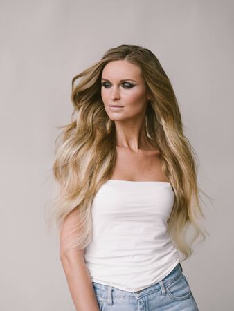 Beautiful woman long hair blonde natural portrait with beauty makeup. Studio shot.の写真素材