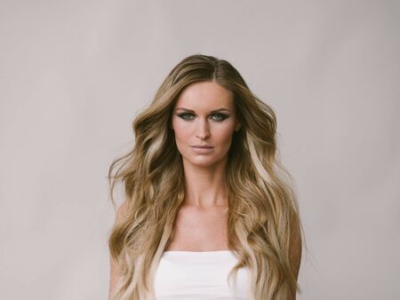 Beautiful woman long hair blonde natural portrait with beauty makeup. Studio shot.の写真素材