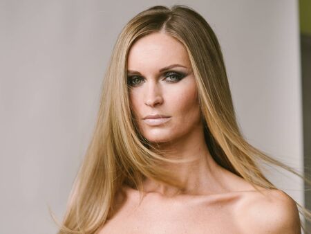Beautiful woman long hair blonde natural portrait with beauty makeup. Studio shot.の写真素材