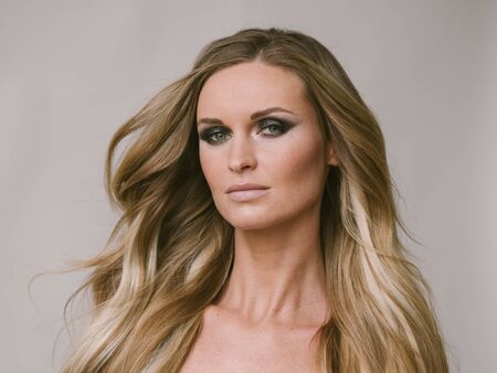 Beautiful woman long hair blonde natural portrait with beauty makeup. Studio shot.の写真素材