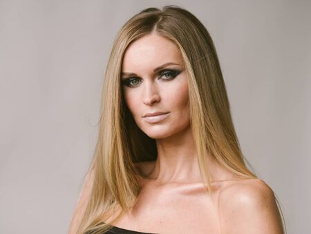 Beautiful woman long hair blonde natural portrait with beauty makeup. Studio shot.の写真素材