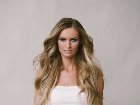 Beautiful woman long hair blonde natural portrait with beauty makeup. Studio shot.の写真素材