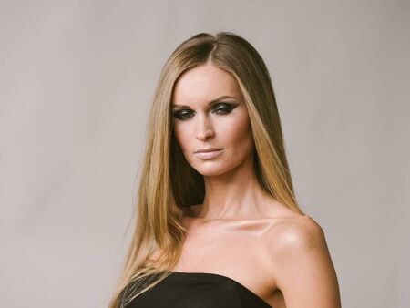 Beautiful woman long hair blonde natural portrait with beauty makeup. Studio shot.の写真素材